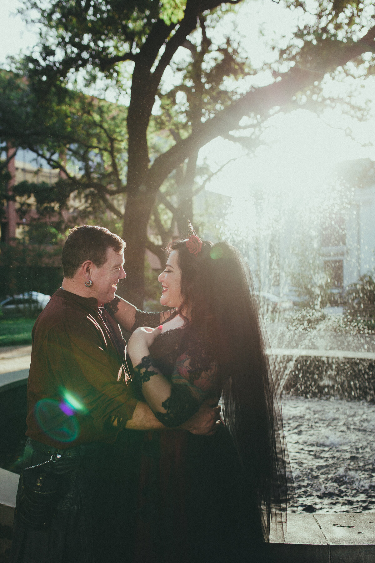 Gothic bride and groom fountain breaking tradition moody wedding photography