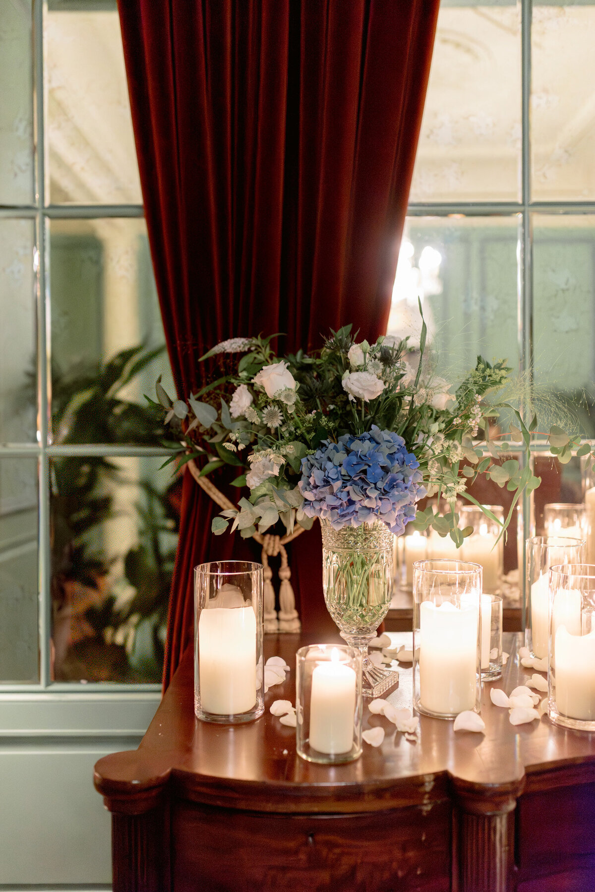 Candlelight and hydrangeo display in the interior ceremony space of Gleneagles Hotel. Image by Scotland wedding photographer, Jill Cherry Porter.