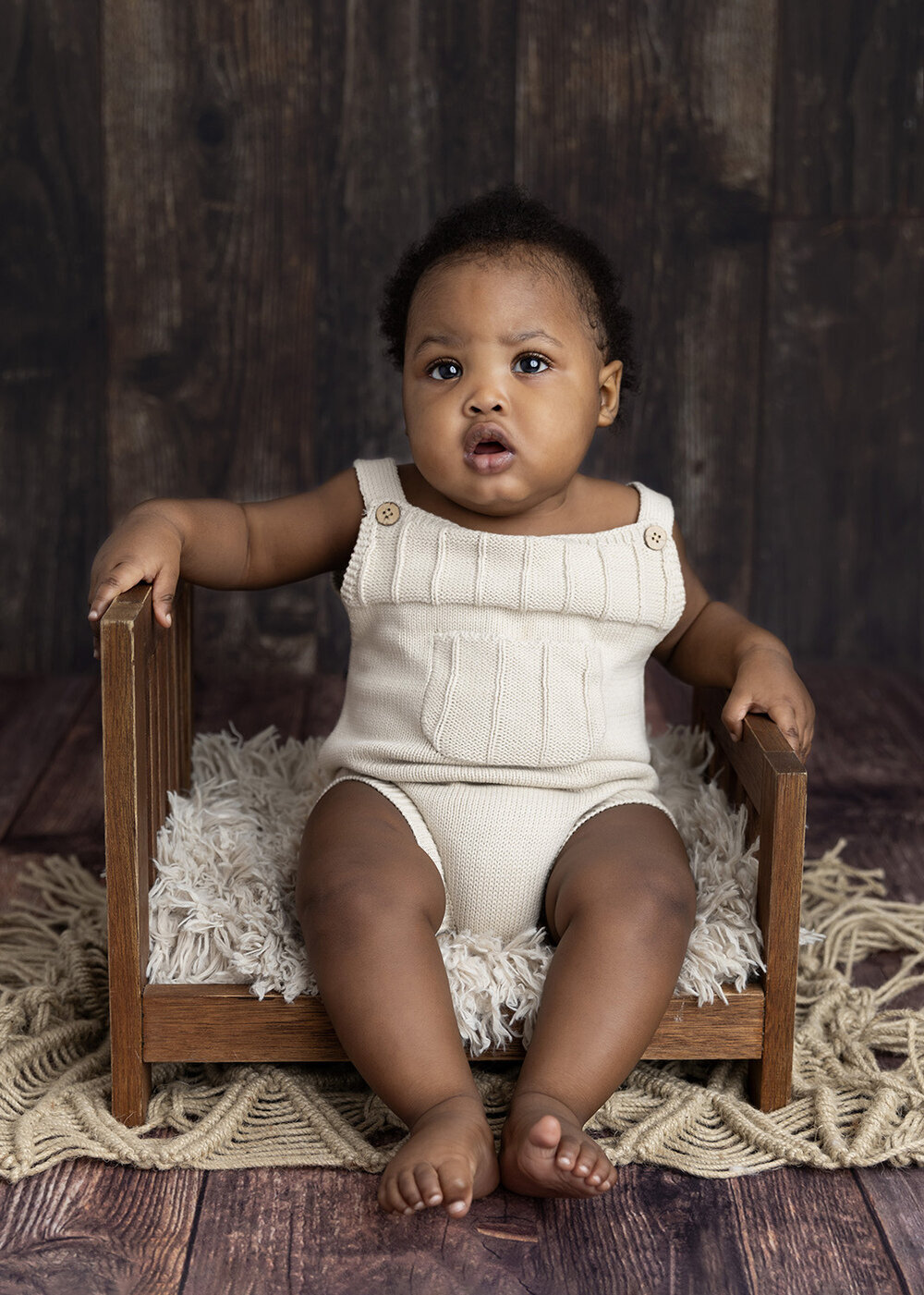 MILESTONE_SITTER_BABYBOYSITTINGONWOODENBABYBED