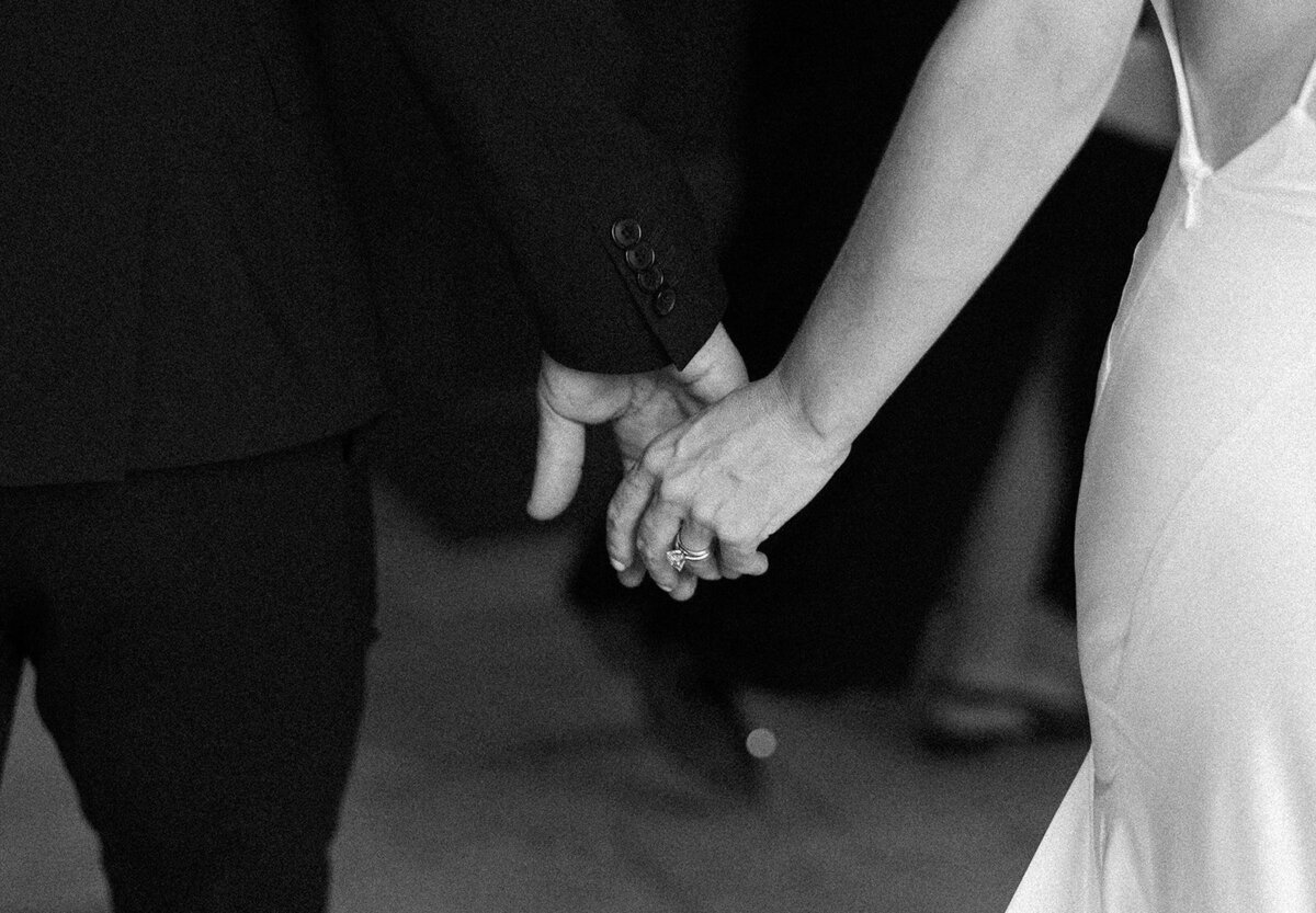 An intimate, artistic shot of the newlyweds’ hands intertwined, symbolizing their love and commitment. Florida Keys wedding photography by Claudia Amalia.