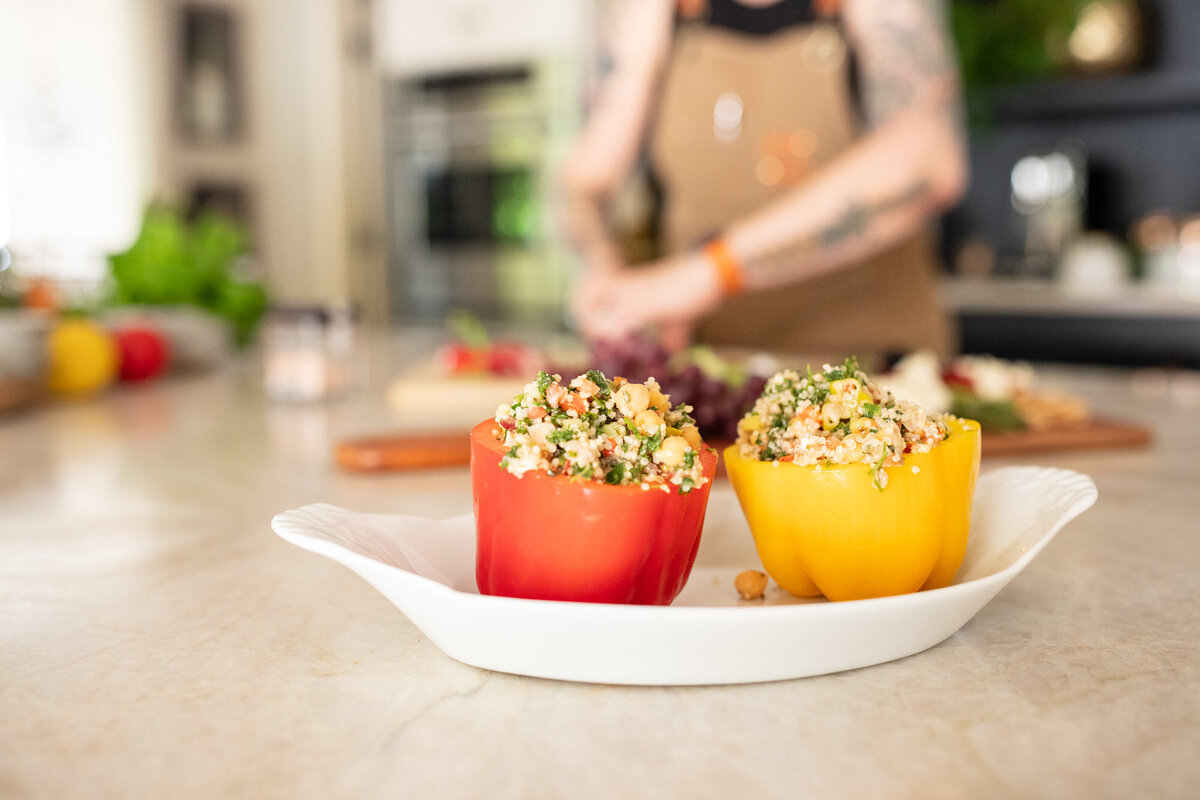 Red and yellow peppers stuffed with quinoa during a photoshoot for a vegan chef with a Portland branding photographer.