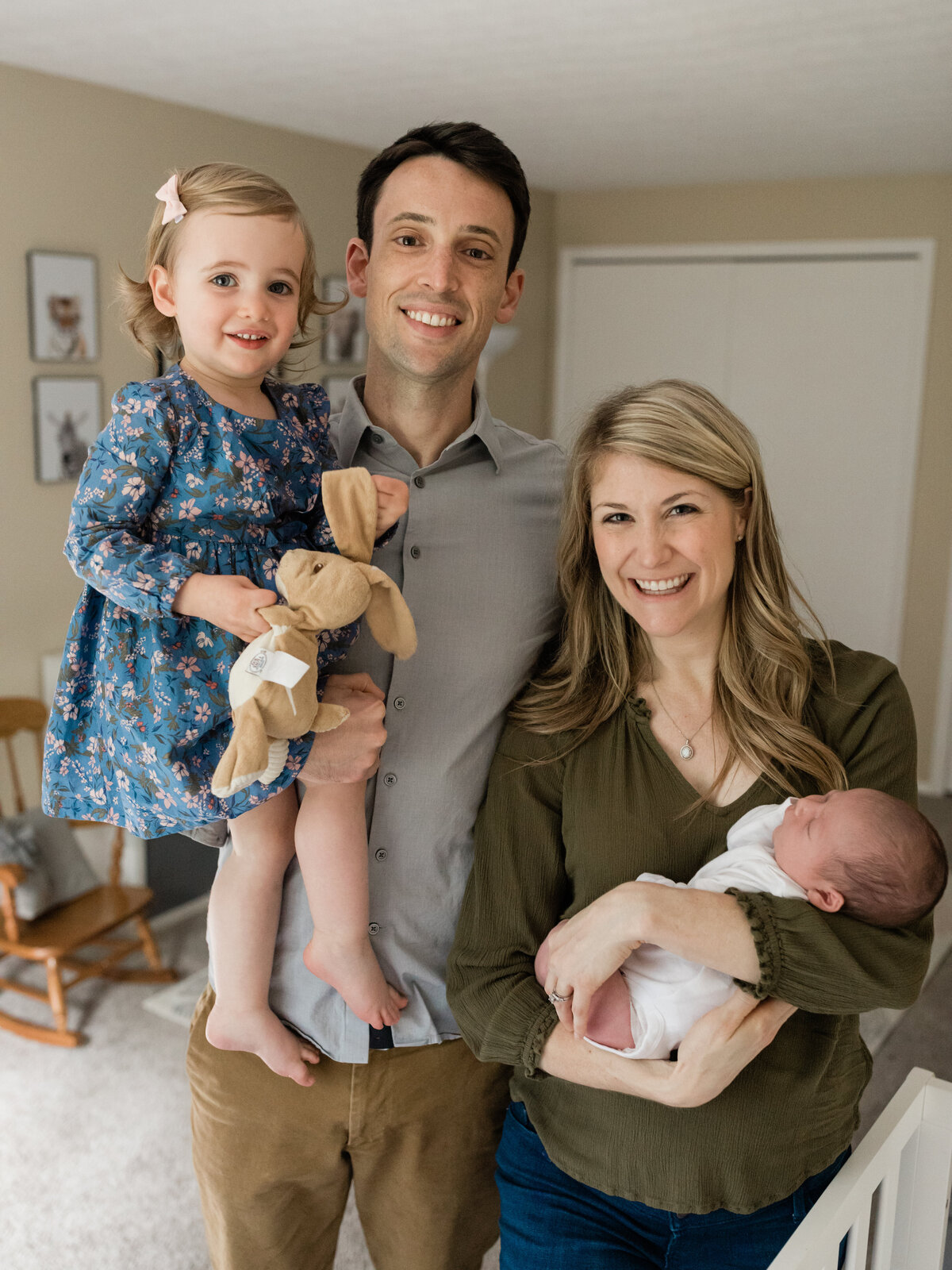 Parents holding daughter and newborn baby boy for in home lifestyle session