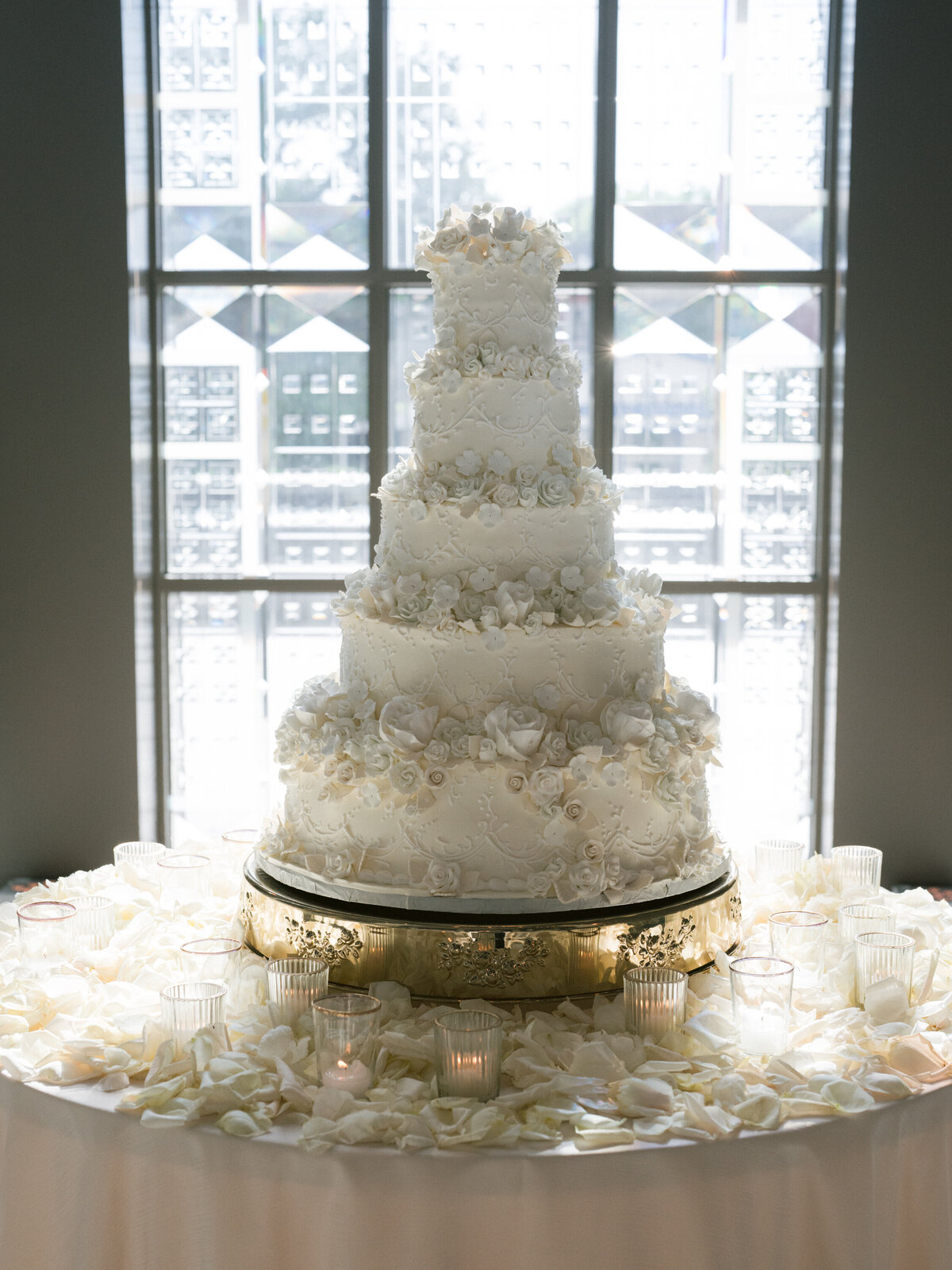 Ornate, elaborate, elegant white wedding cake covered in sugar flowers in Nashville, TN
