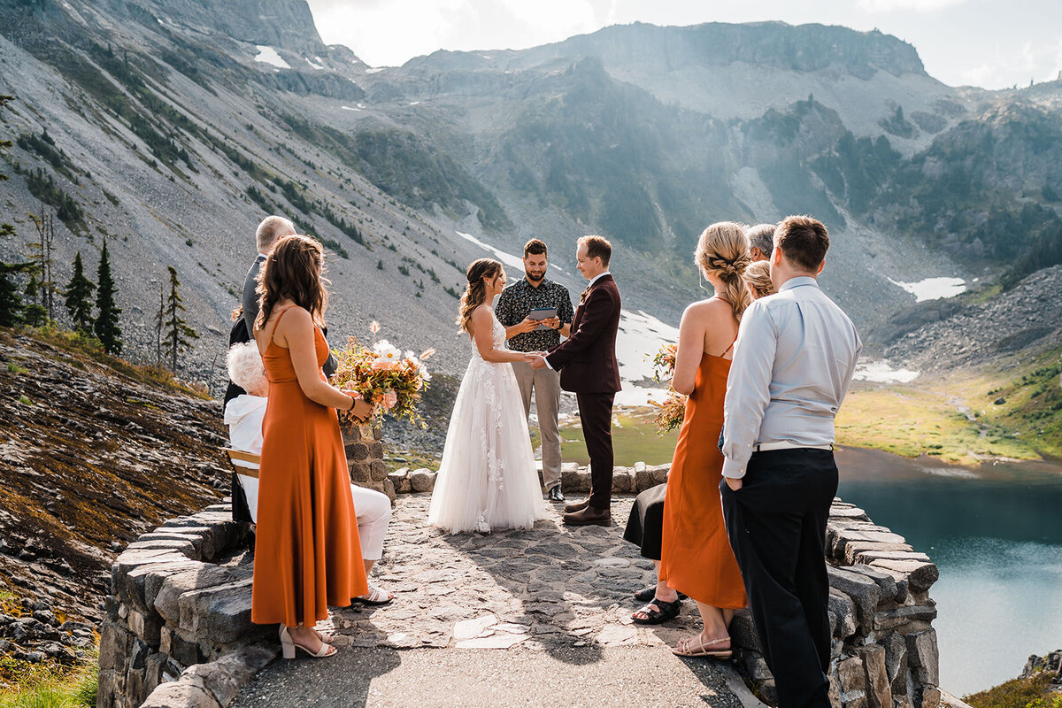 Bride & groom holding hands during elopement ceremony in the North Cascades overlooking Bagley Lakes & Table Mountain!
