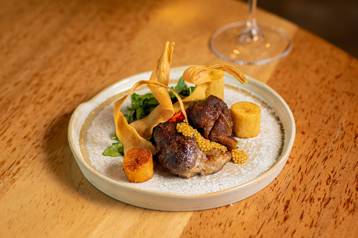 A plate of Pork Cheek is displayed at Cafe Vino in Fort Collins, Colorado.