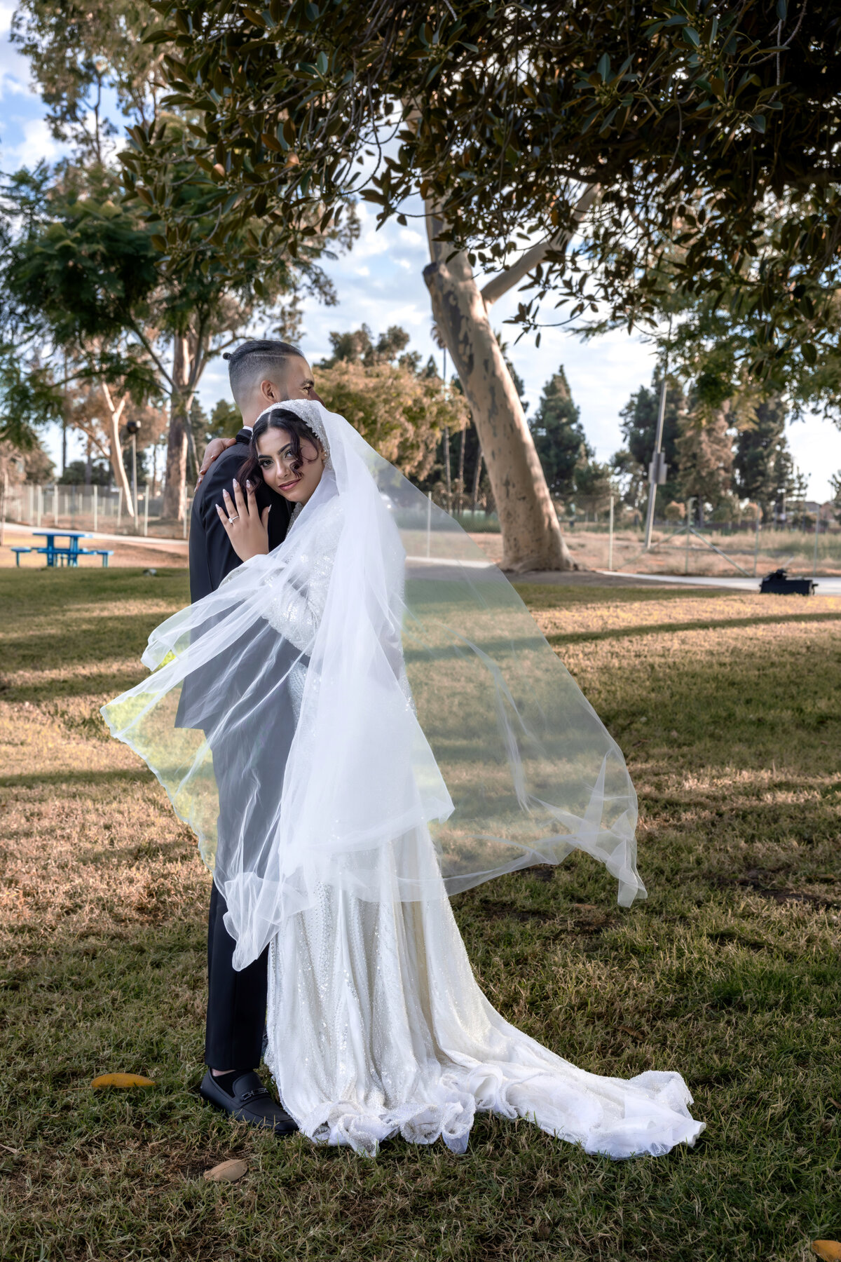 Bride Hugging Groom Under Tree – Elegant Los Angeles Wedding Portrait