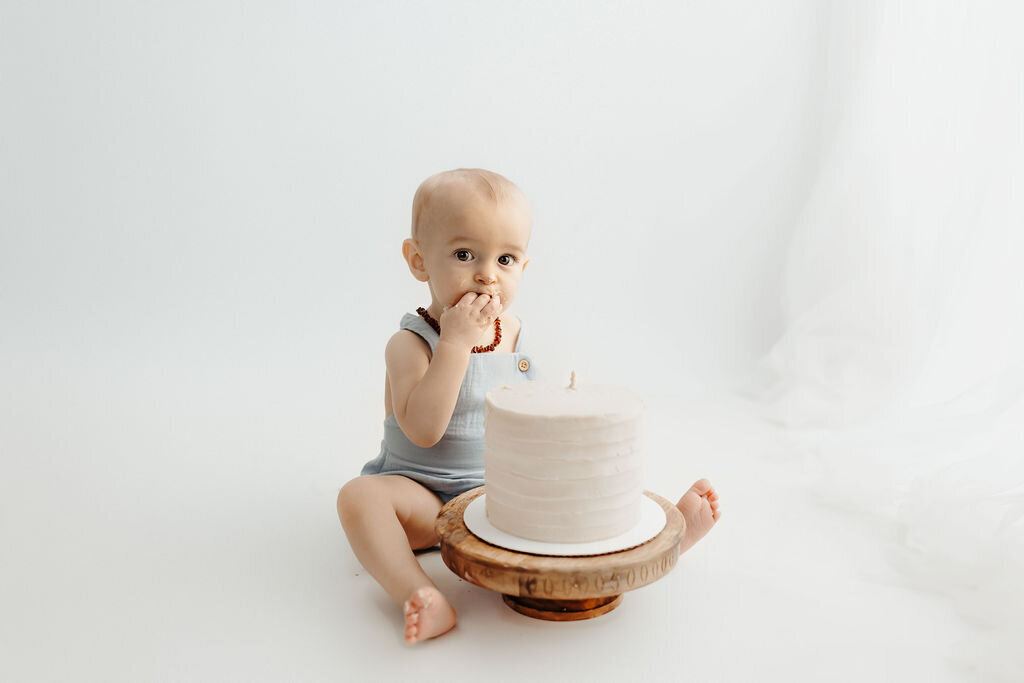 bright and airy cake smash photos of llittle boy in our our loveland studio