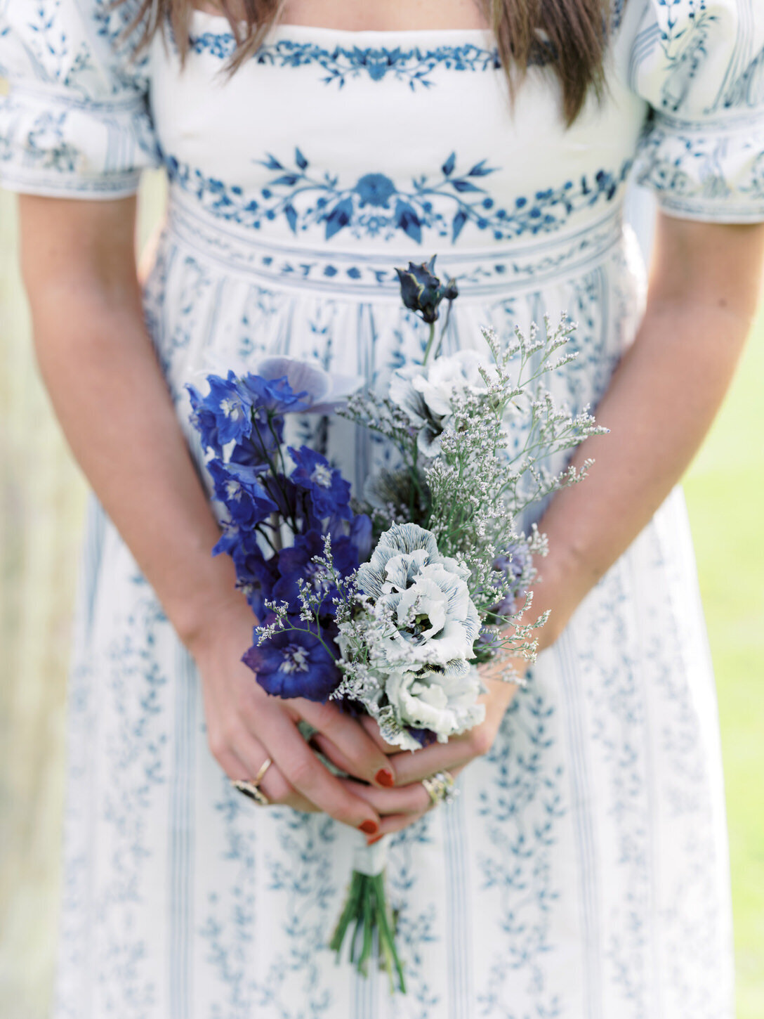 adirondack-mountain-wedding-14-close-up-of-floral-bouquet-by-hudson-botanica-featuring-blue-and-white-blooms-at-adirondack-mountain-wedding-jenny-fu-studio