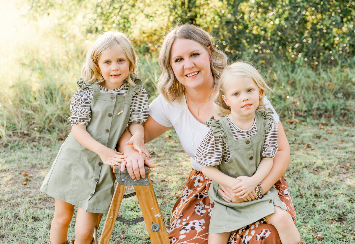 mother with her young daughters at christmas minis at golden hour