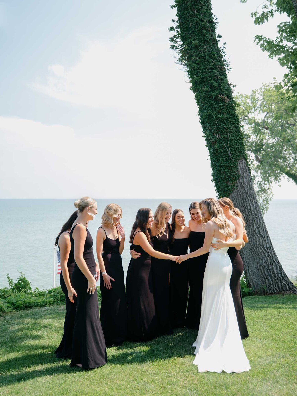 Bride's first look with her bridesmaids in front of Lake Erie