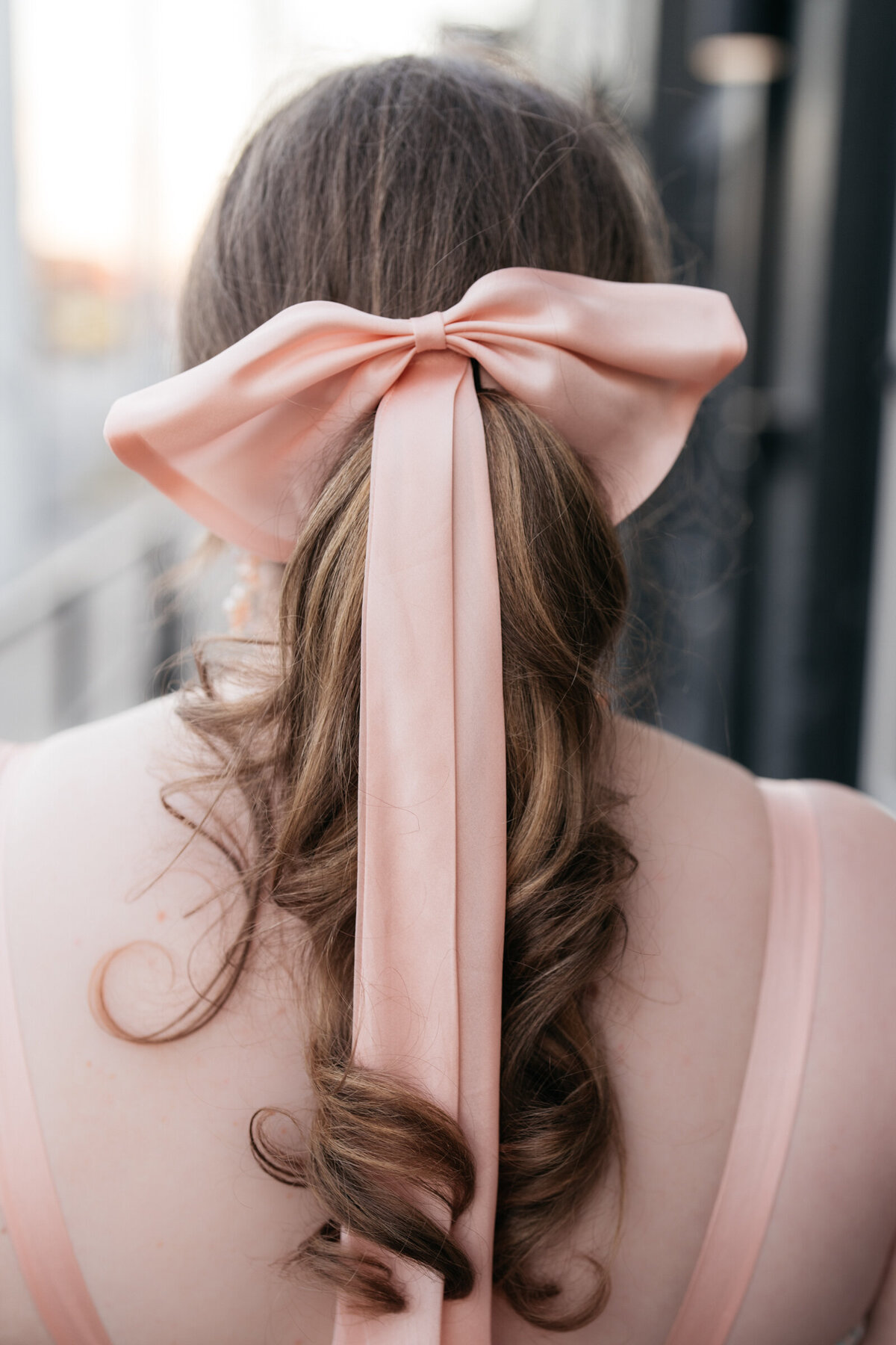 bride wearing a pink hair bow