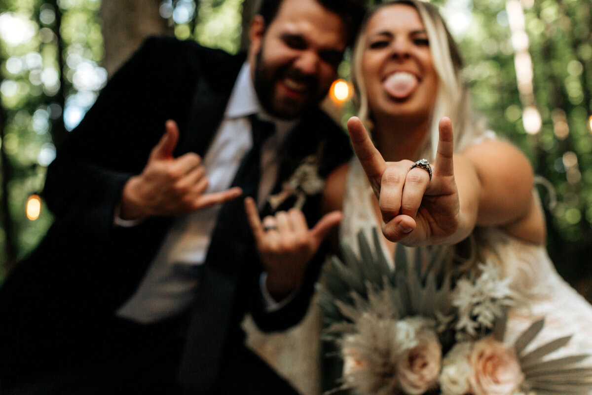 bride and groom with rocker hands