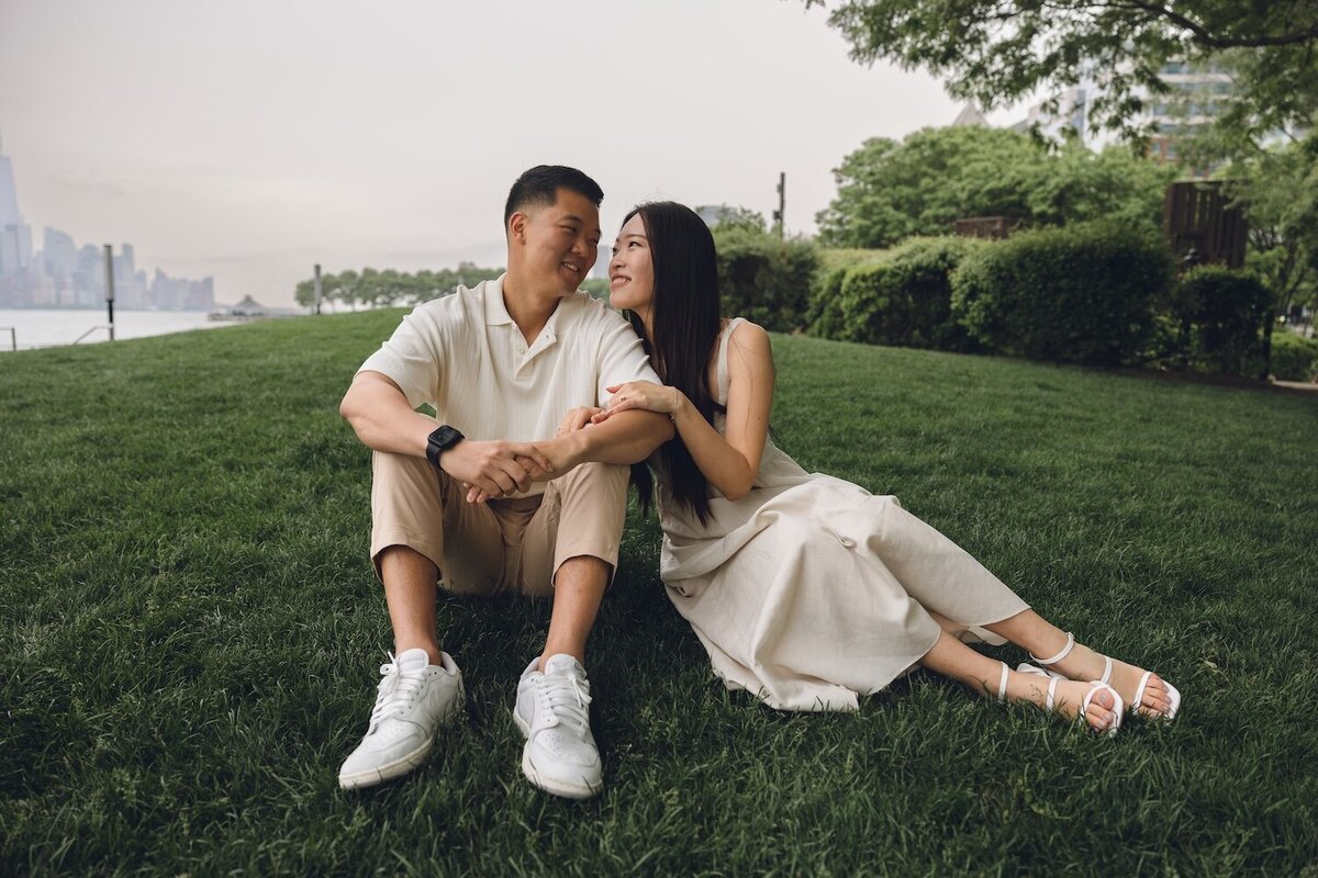 Romantic close-up of couple cuddled together on Hoboken lawn