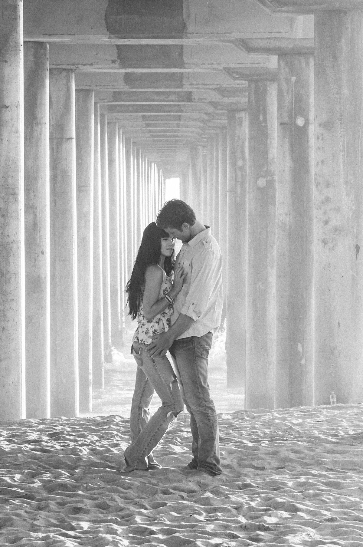 Couple embracing under the pier