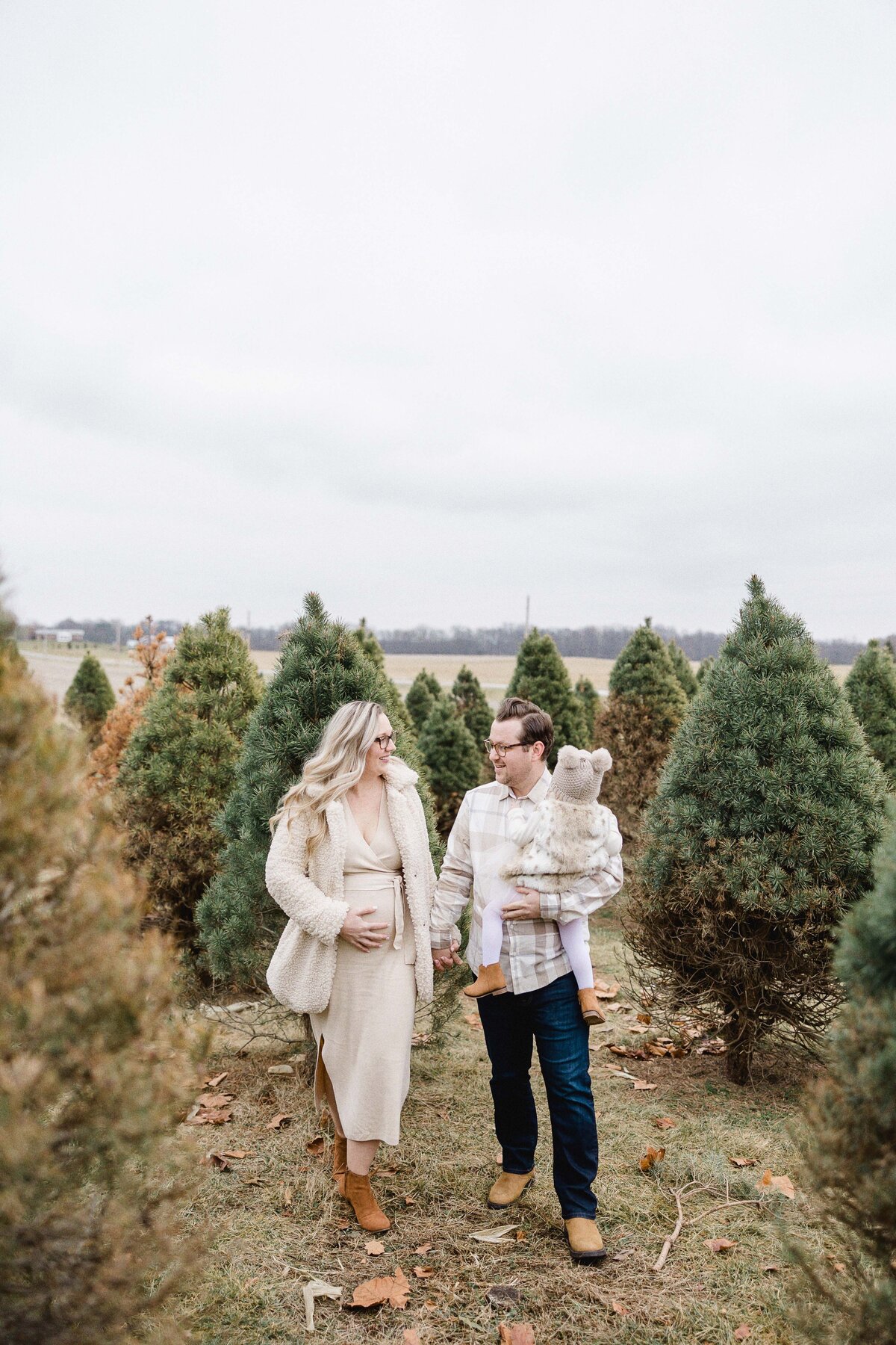 family walking through tree farm