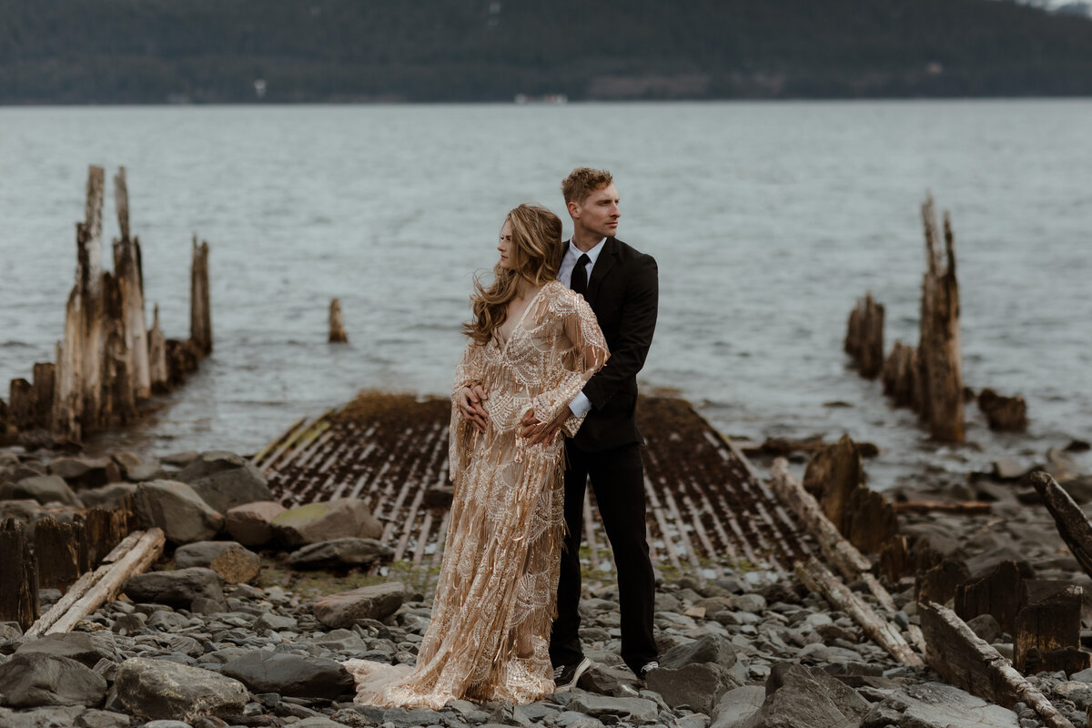 bride and groom posing on dock