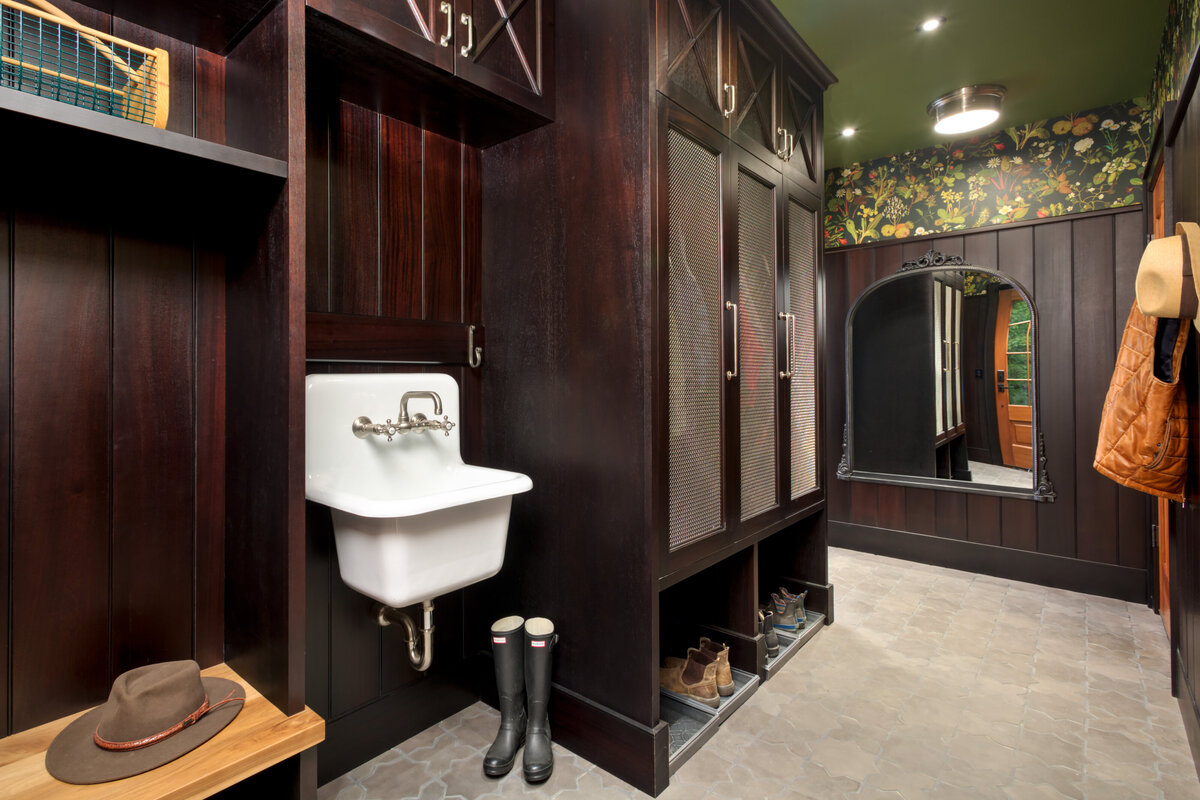 dark wood wet room with white skink and storage