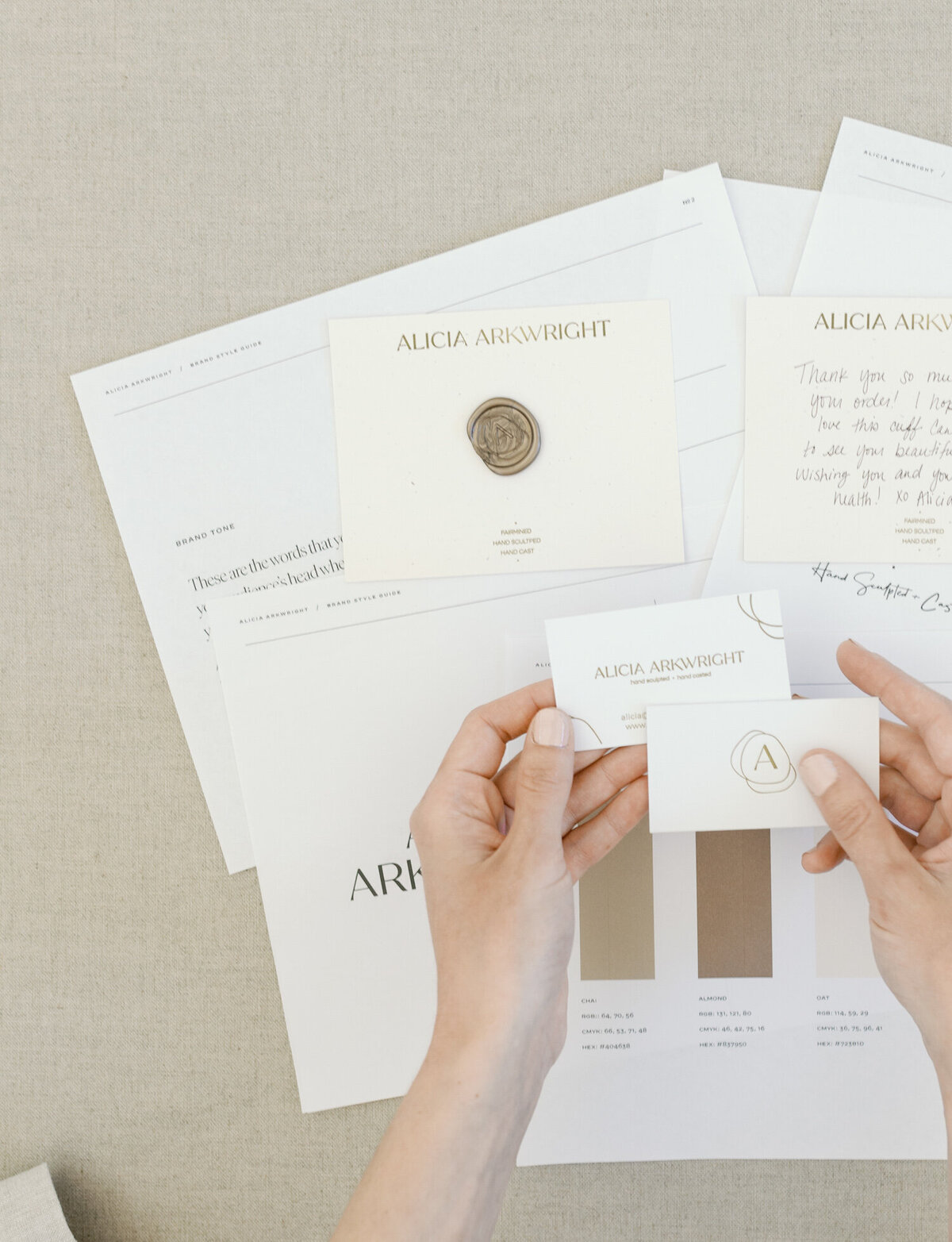 flatlay with brand elements, print materials, hands, designer film branding photos