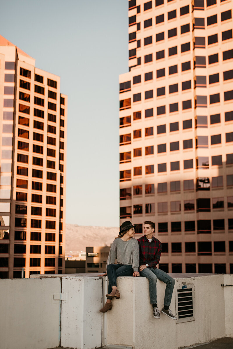 Couple sitting on a rooftop downtown Albuquerque