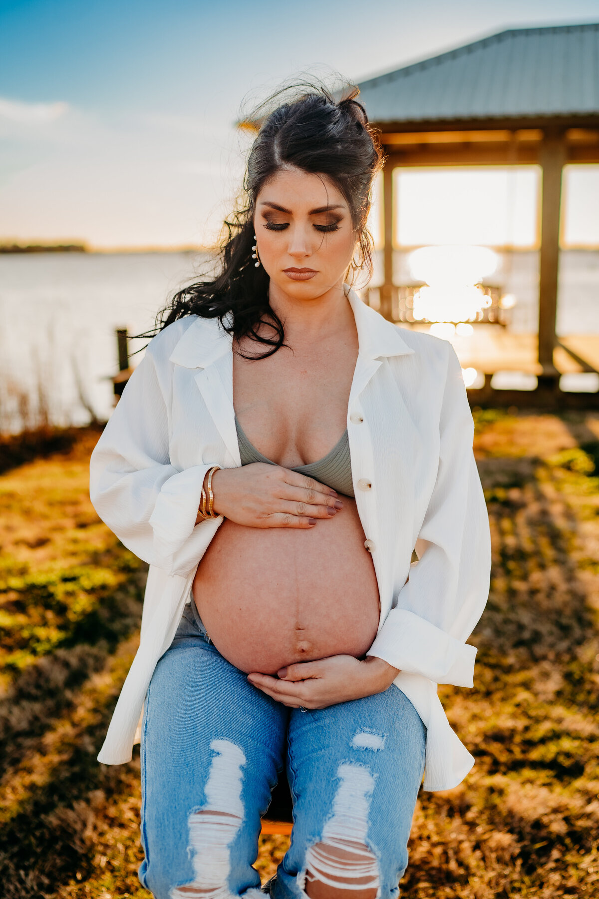 close up of exposed belly pregnancy pose at lake peigneur, new Iberia, la