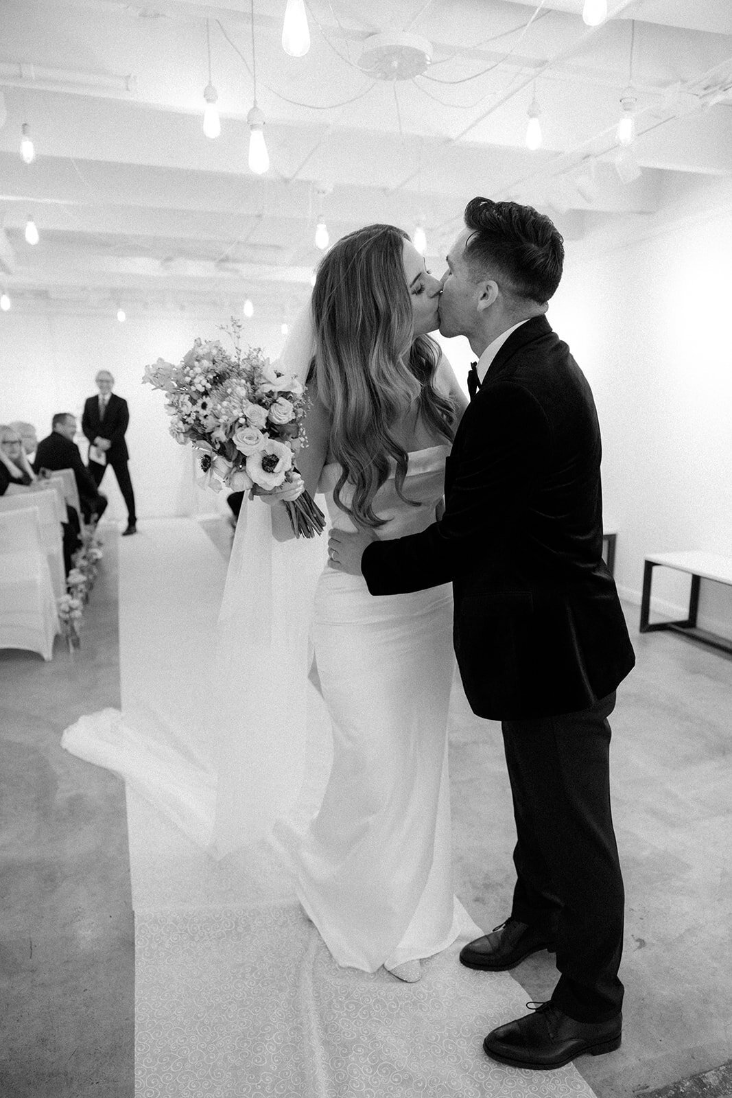 Bride and groom share a candid kiss after their intimate wedding ceremony in Nashville, TN. 