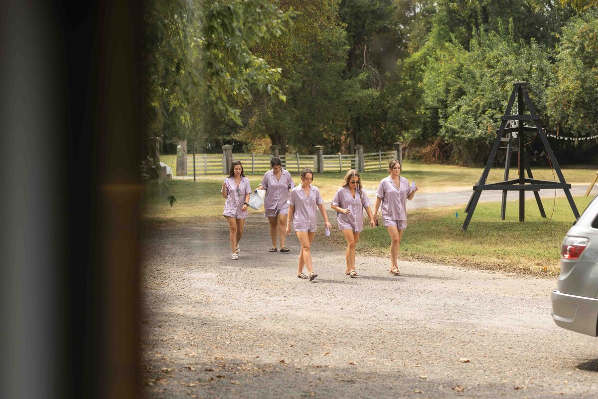 Bridesmaids in wedding day robes walking together 