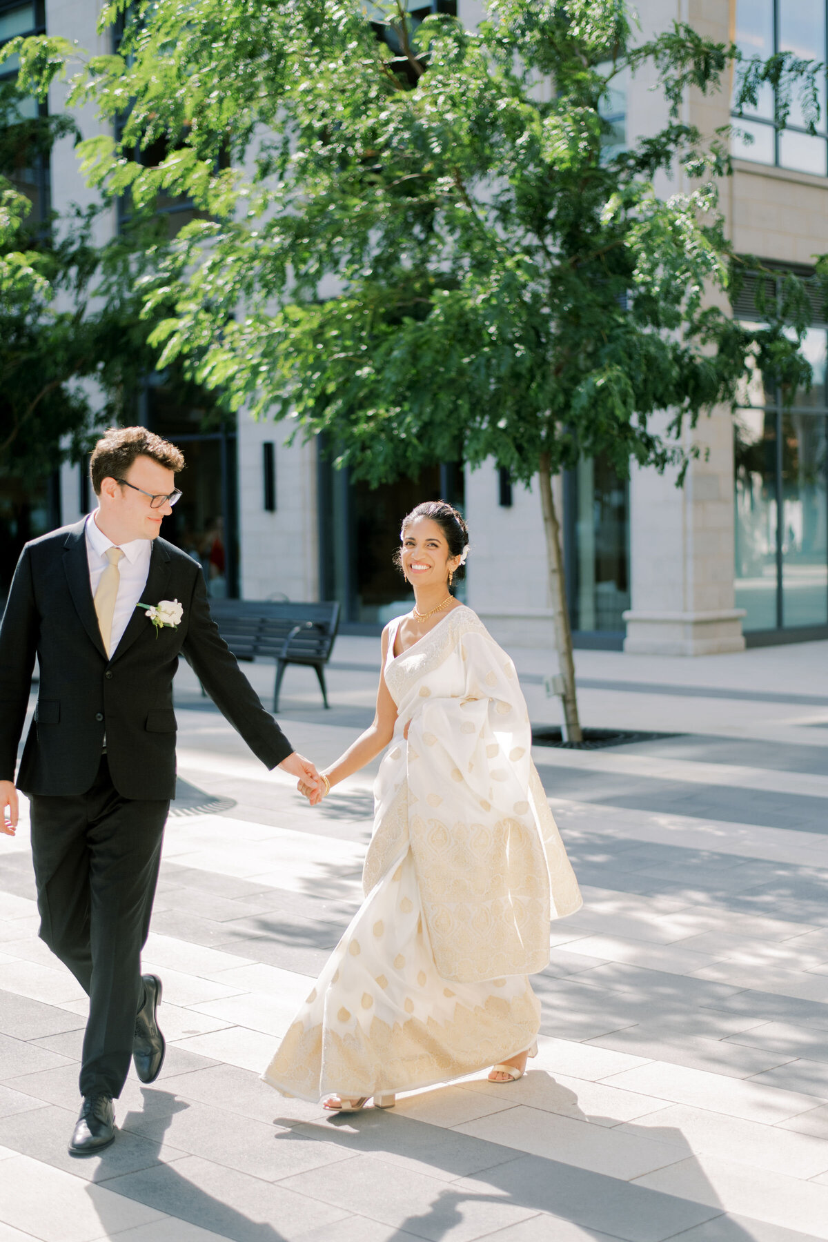 bride and groom walking holding hands the beautiful location at the pearle hotel in burlington
