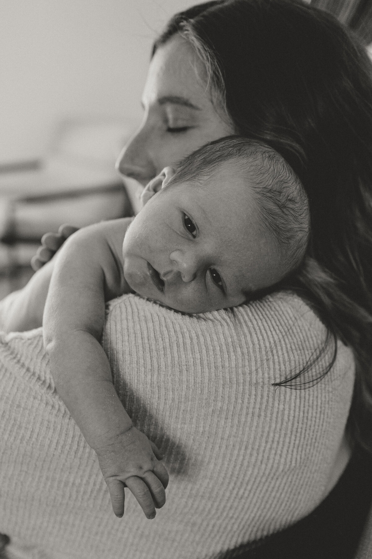Longmont newborn being pat over moms shoulder