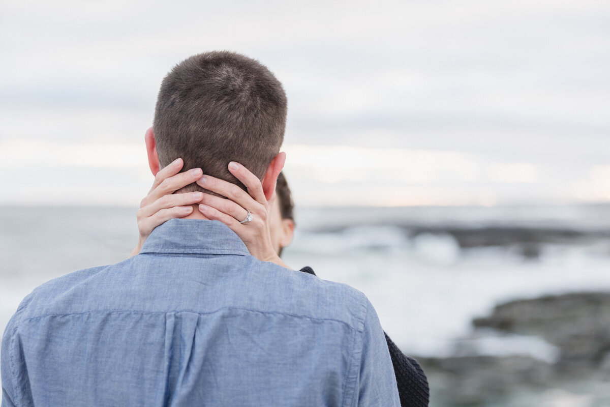 Couple share a private moment during their engagement shoot in Newport