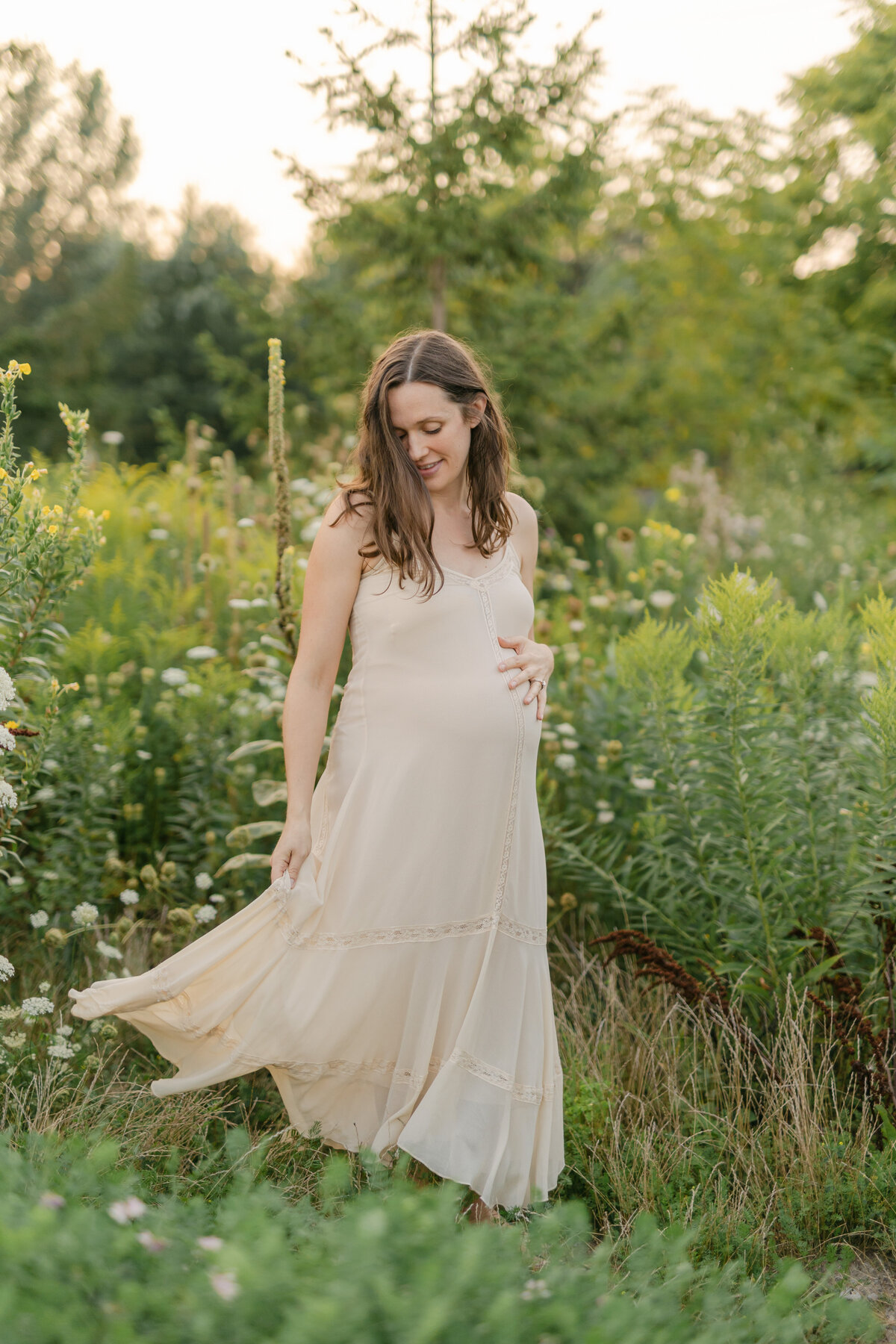 pregnant woman in beige dress in a field