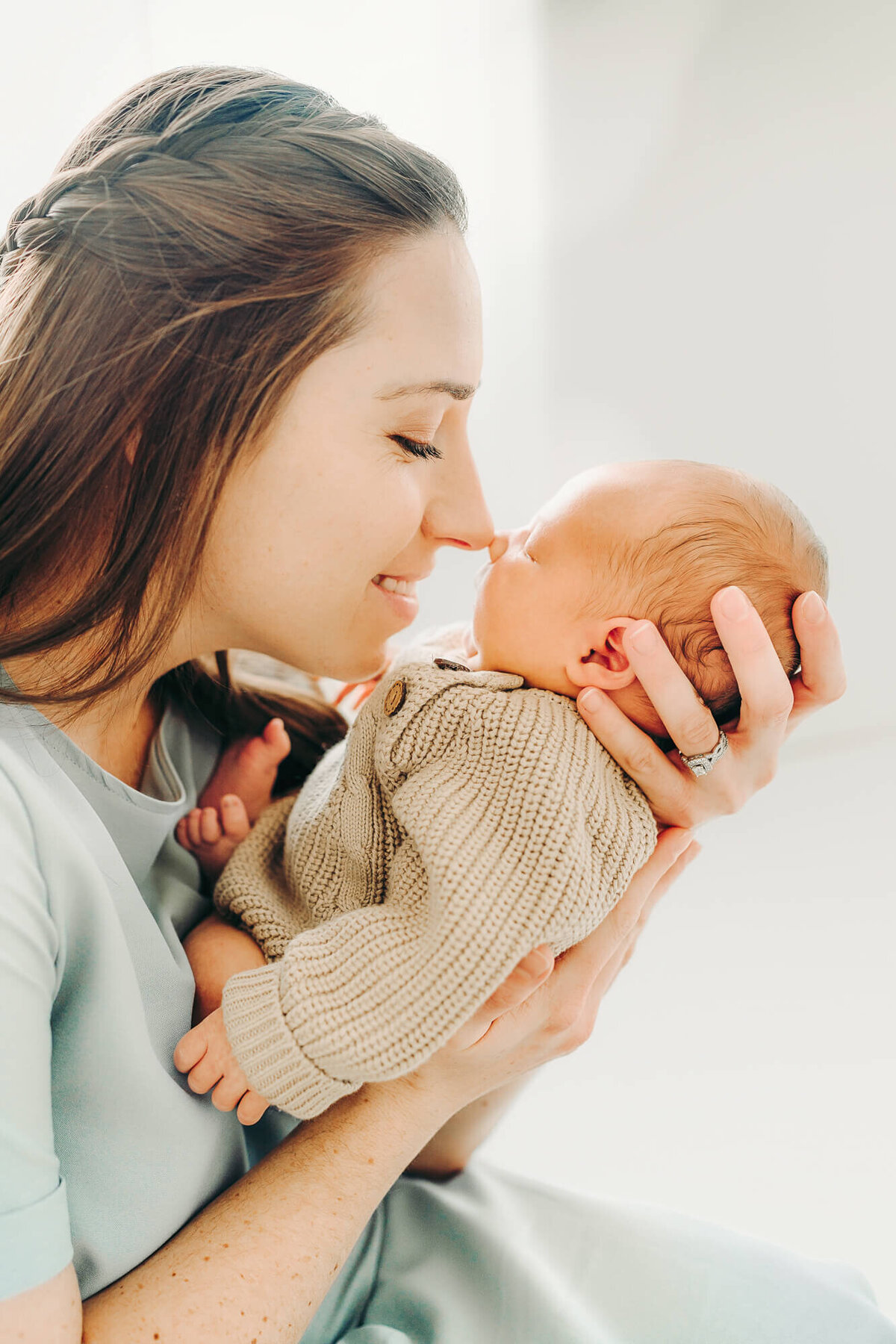 new mom nuzzles baby boy  during newborn session in jackson missouri