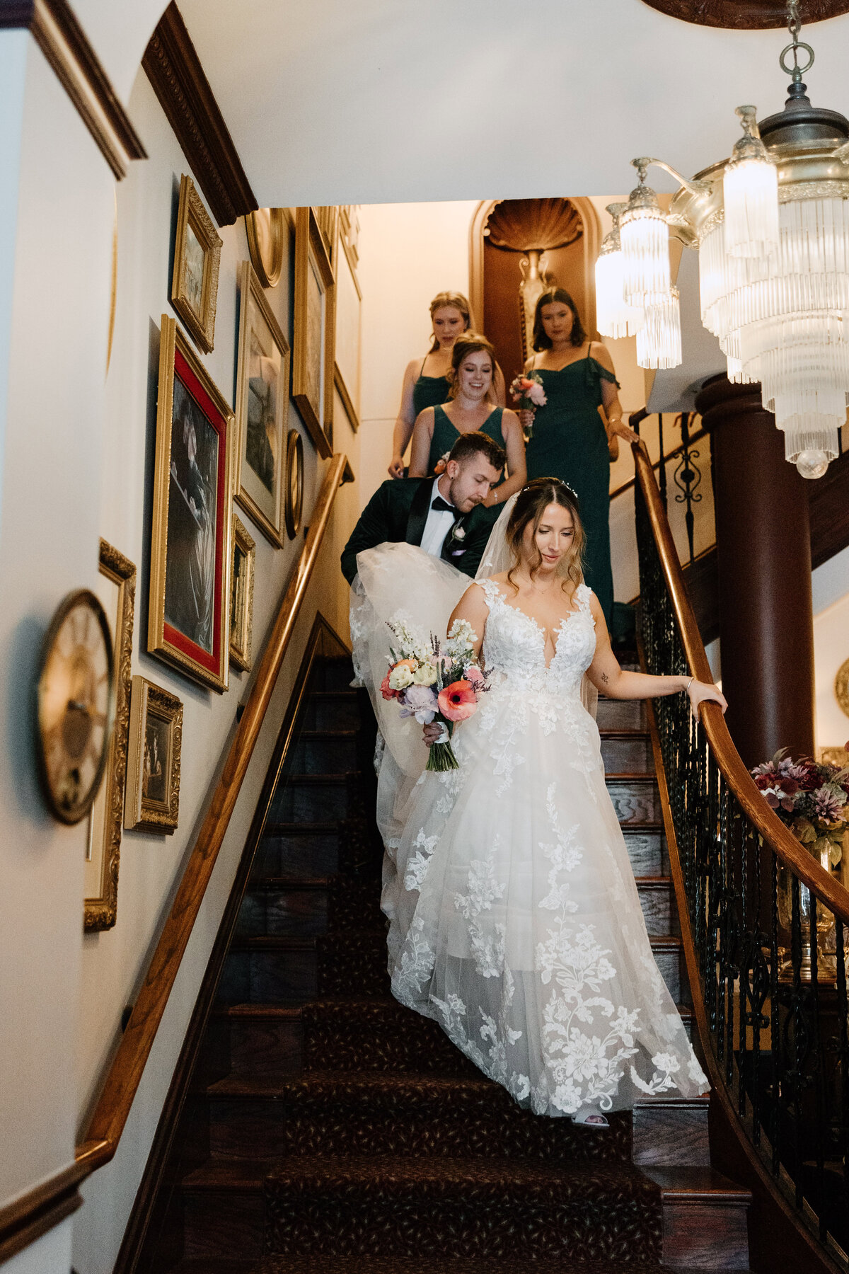 Bride and her entourage walking down the grand staircase of Carleton Grand Hotel in Ontario