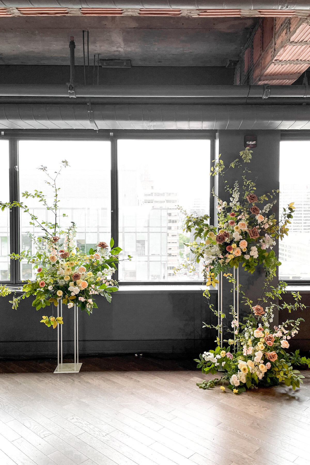 Large airy garden flower arrangements for a wedding ceremony at the Reine Elizabeth Hotel. 
