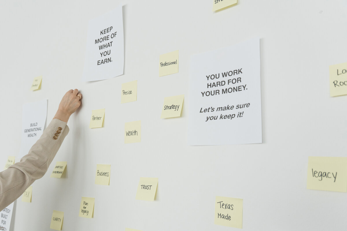 Yellow sticky notes displaying brand keywords for Romo CPA Tax + Advisory, highlighting expert Dallas business tax services for entrepreneurs.