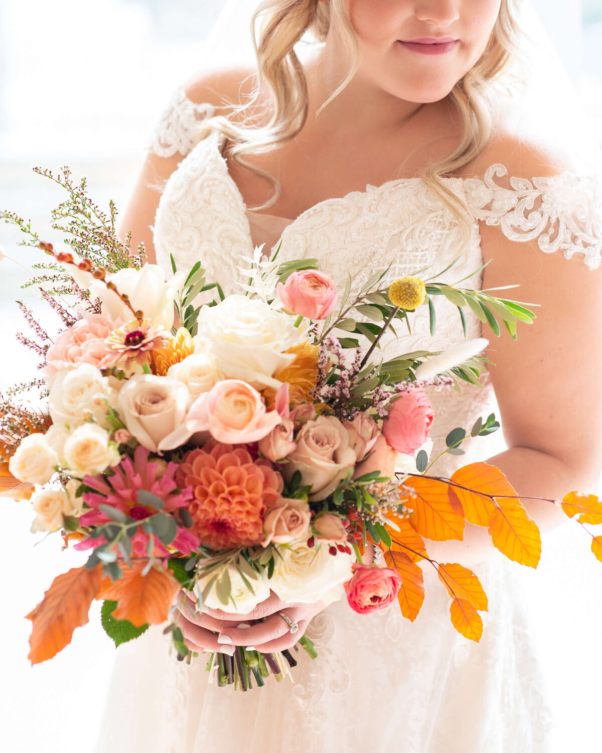 close of bride's fall bouquet by Riverwood Gardens for her Ottawa wedding at Strathmere wedding venue
