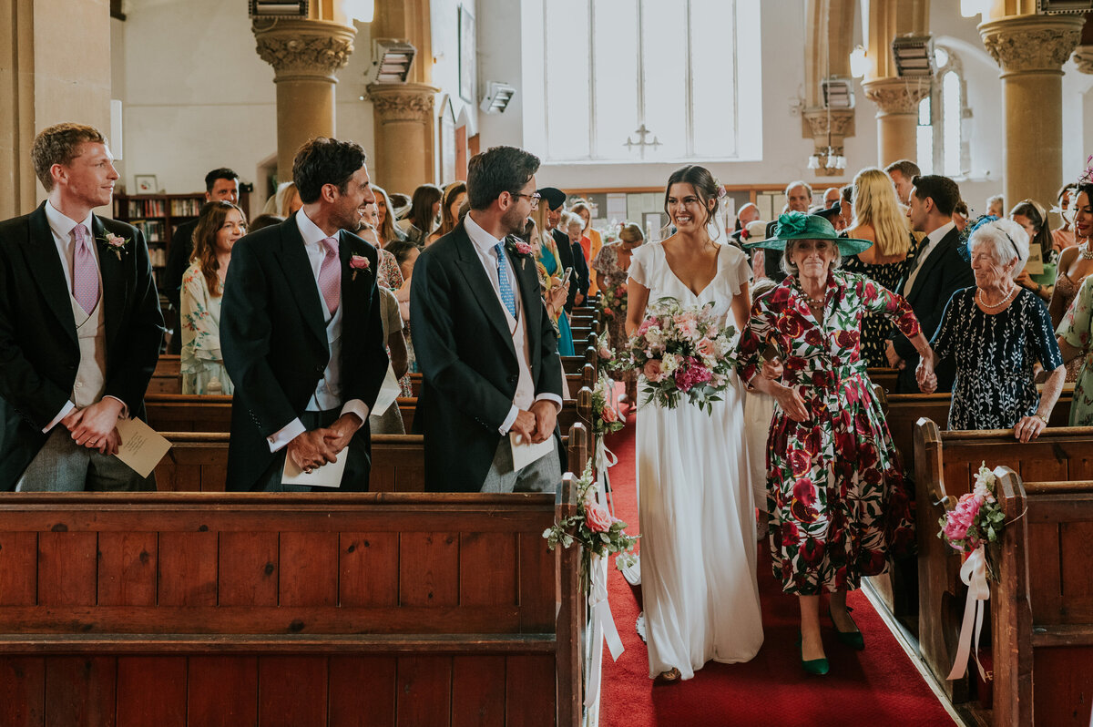 Bride Walking down isle with grandmother in church