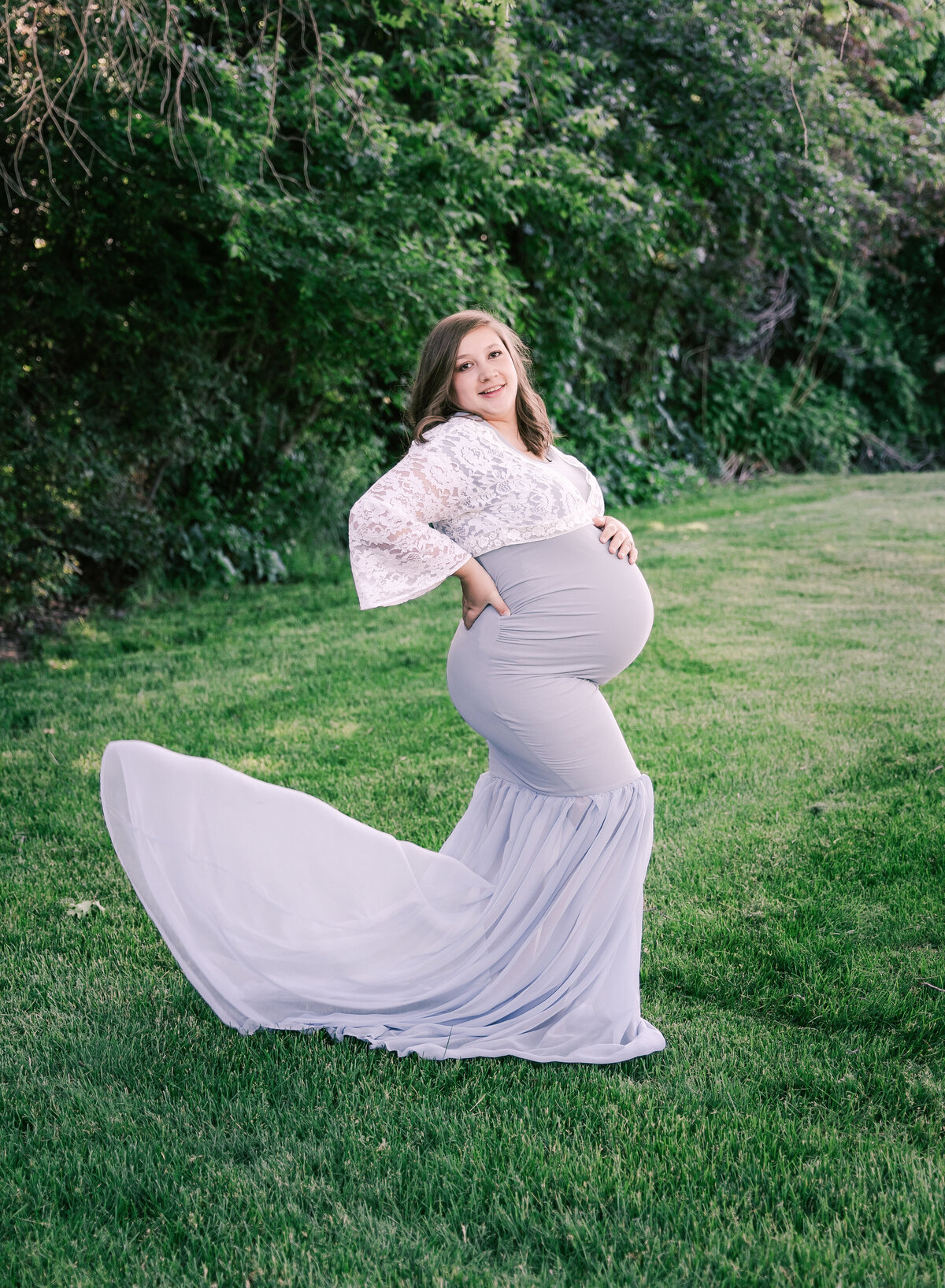 A flowing maternity gown in light blue in a photo by Diane Owen Photography.