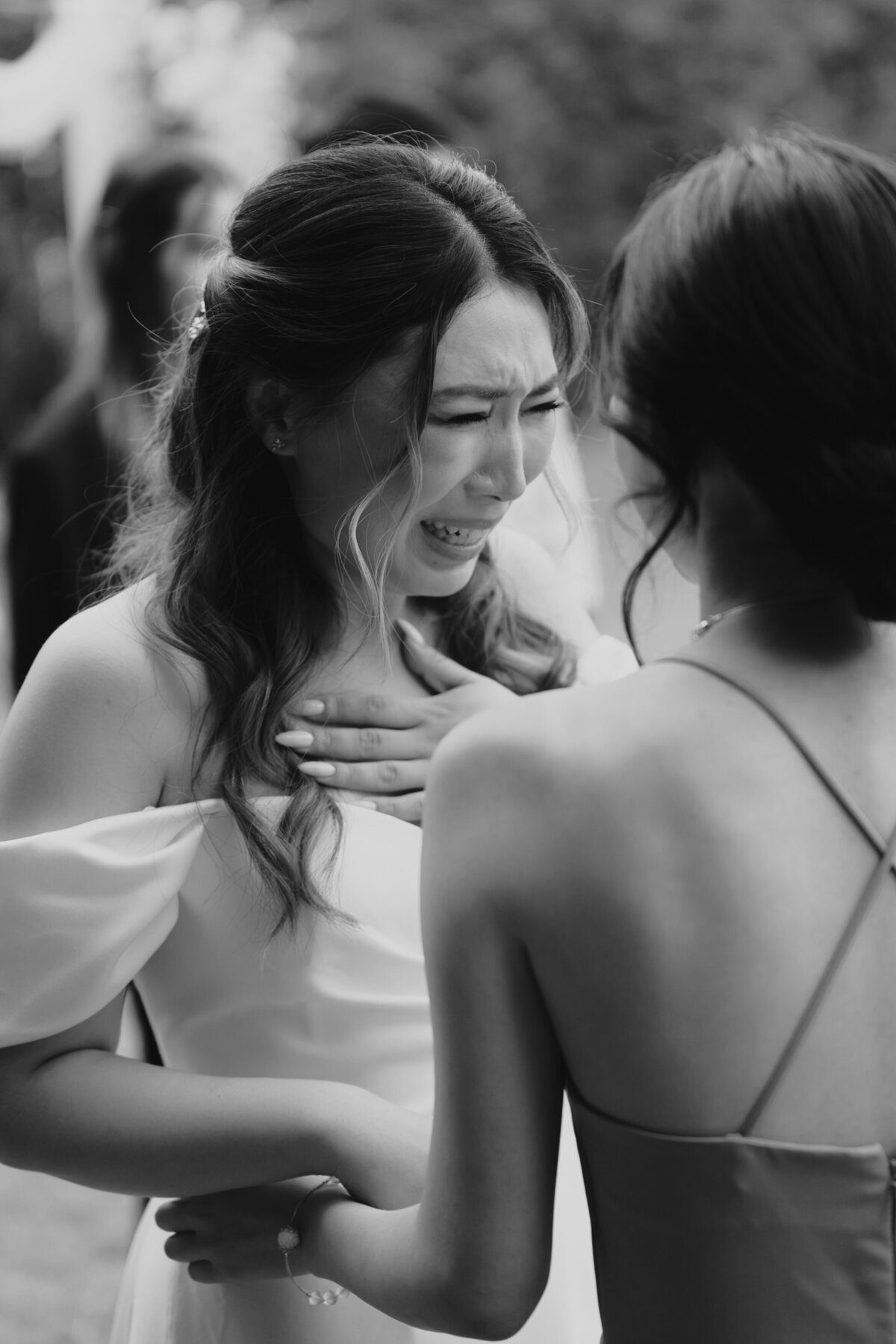 the bride teary eyes while talking to her friend