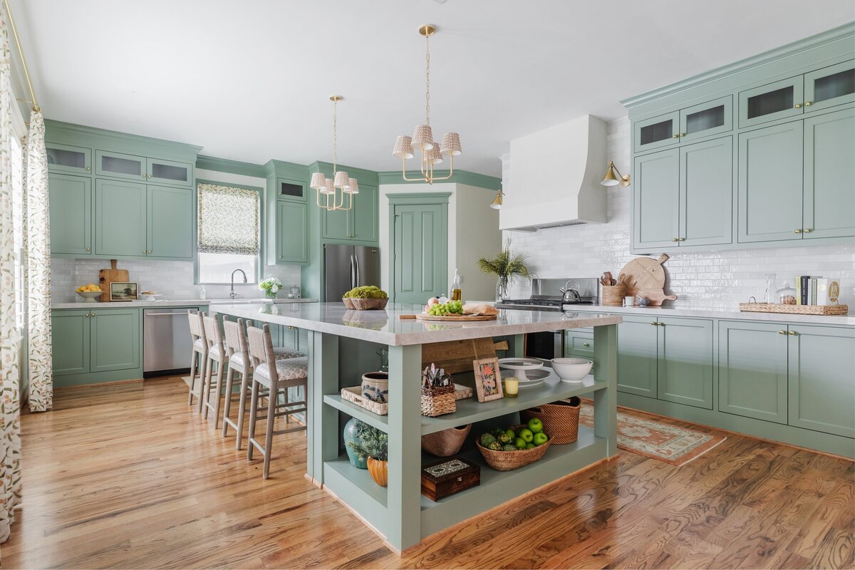 oyster creek studios oak forest remodel  light sage kitchen with tan stools and marble counters