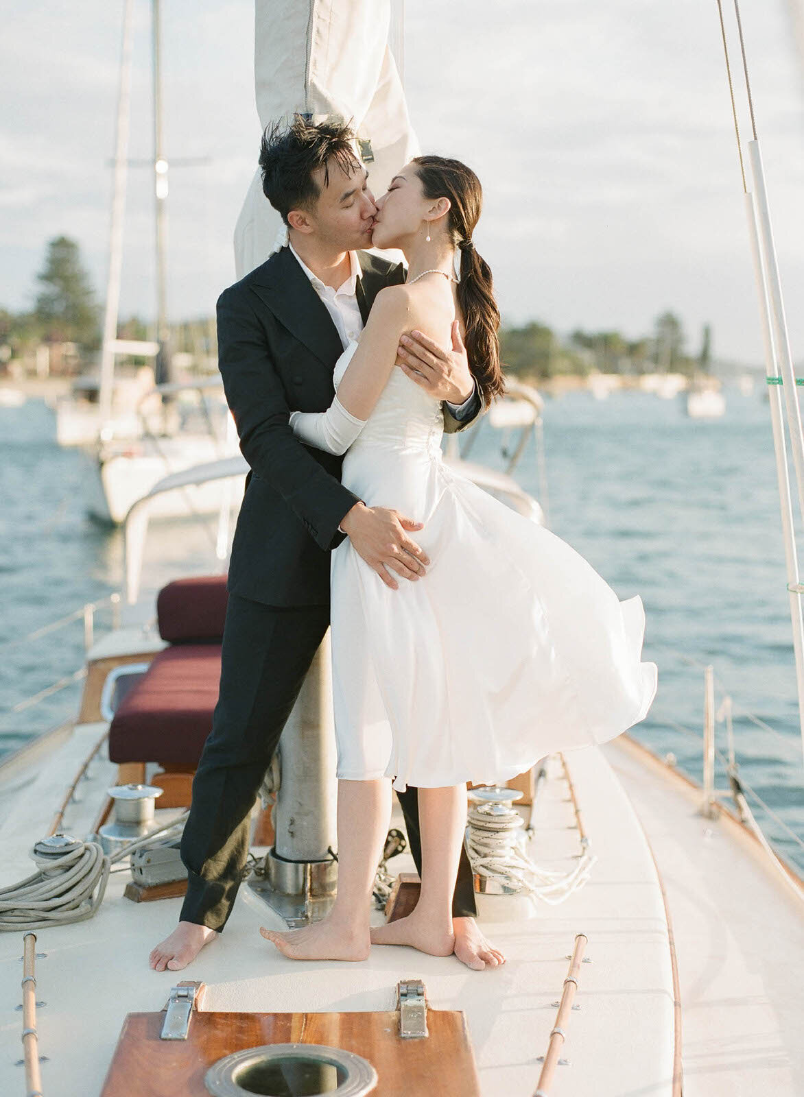engaged couple's kiss on a sailboat