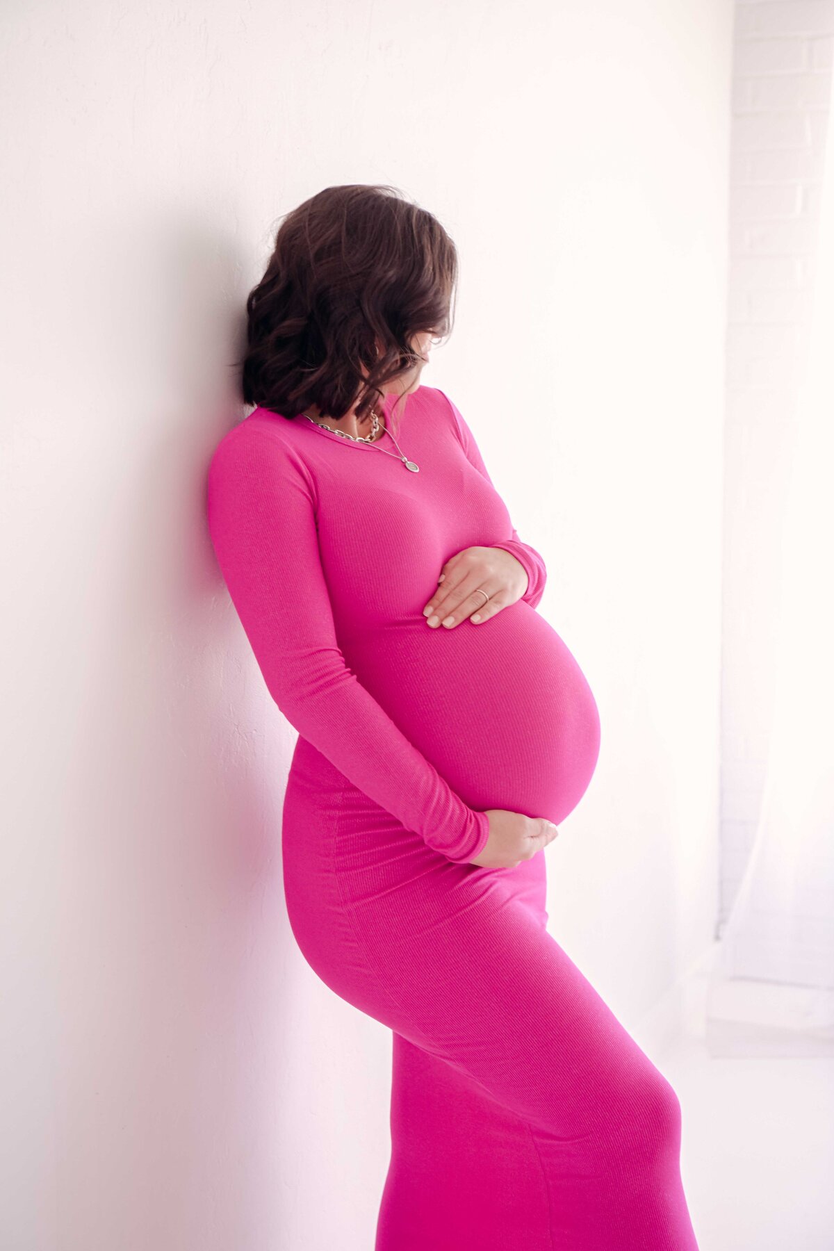 Maternity silhouette in pink dress at Oklahoma City studio.