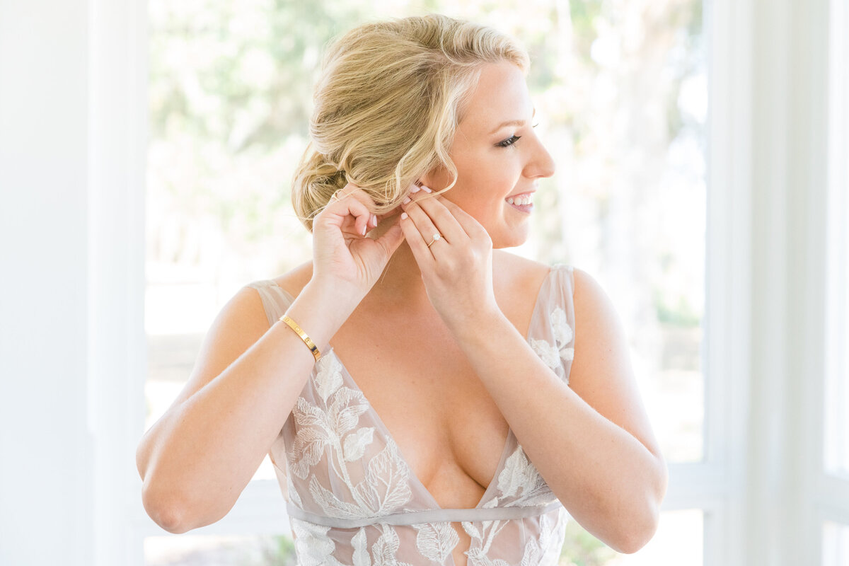 Bride getting ready before her Veuve-inspired wedding at Palmetto Bluff in Charleston, SC. Photographed by Charleston Wedding Photographer Dana Cubbage.