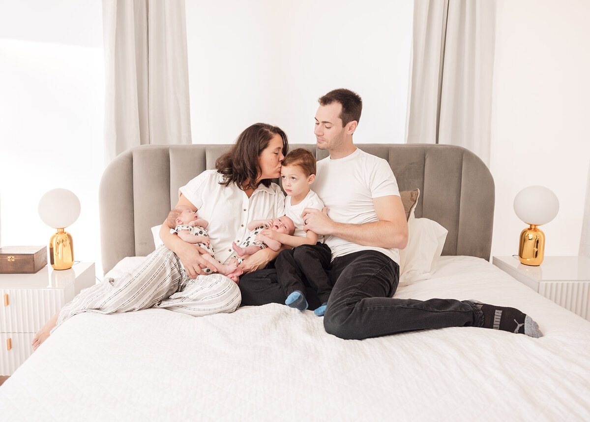 Mother holding newborn during in-home lifestyle photo session in Central Florida

