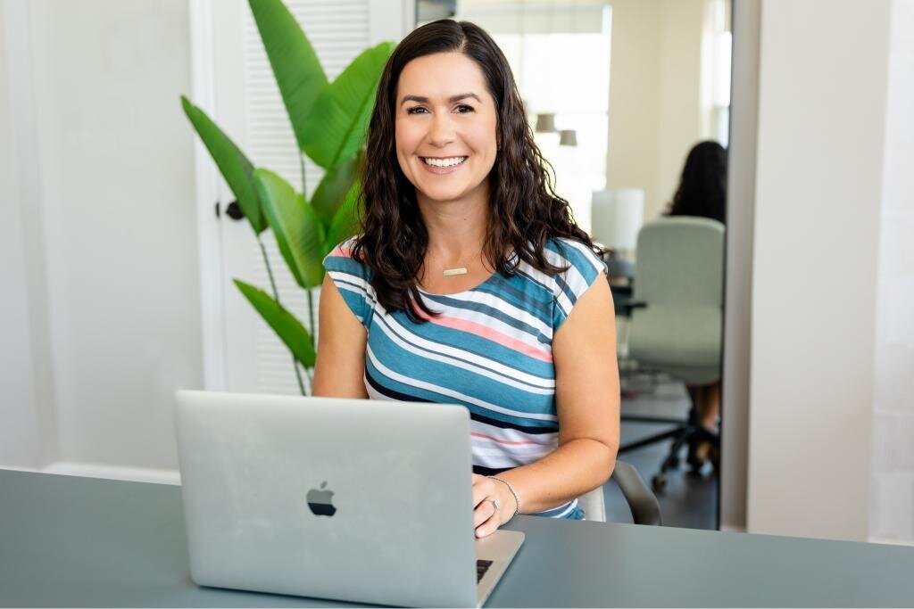 Angie at her table with a laptop, perfect for personal branding, remote work, and professional setups. Ideal for showcasing productivity and workspaces.