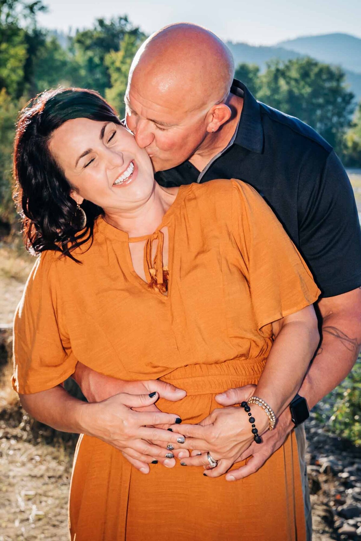 Missoula married couple kissing along Clark Fork River