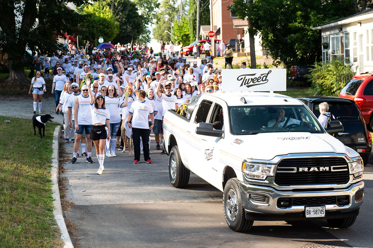 Tweed organizers of the Pride Parade driving a truck and waving a flag.  Captured by Ottawa Event Photographer JEMMAN Photography COMMERCIAL