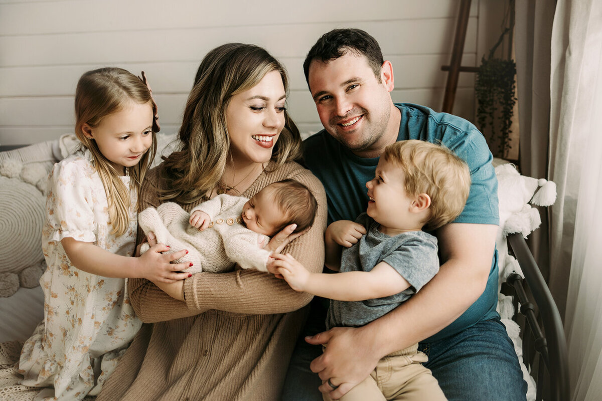 Fort Collins family celebrating and loving on their new baby brother