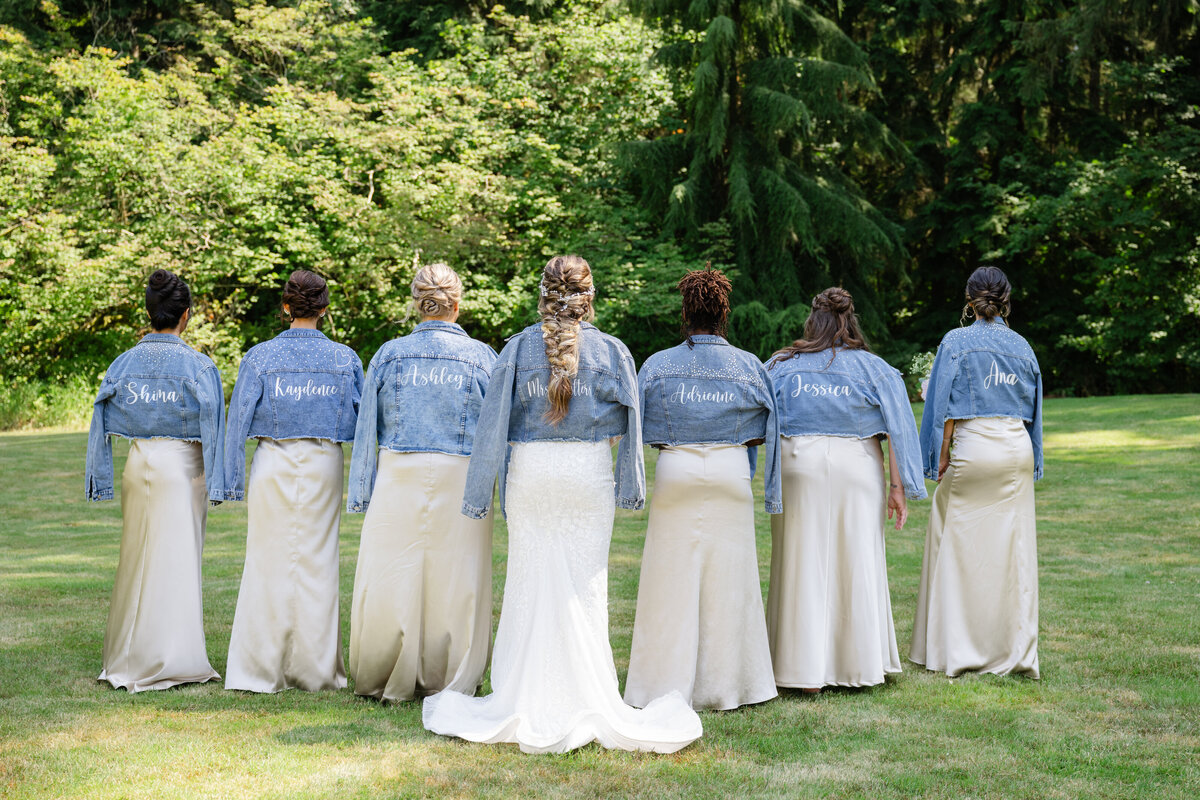 bridal party in champagne colored dresses and jean jackets outdoor wedding 