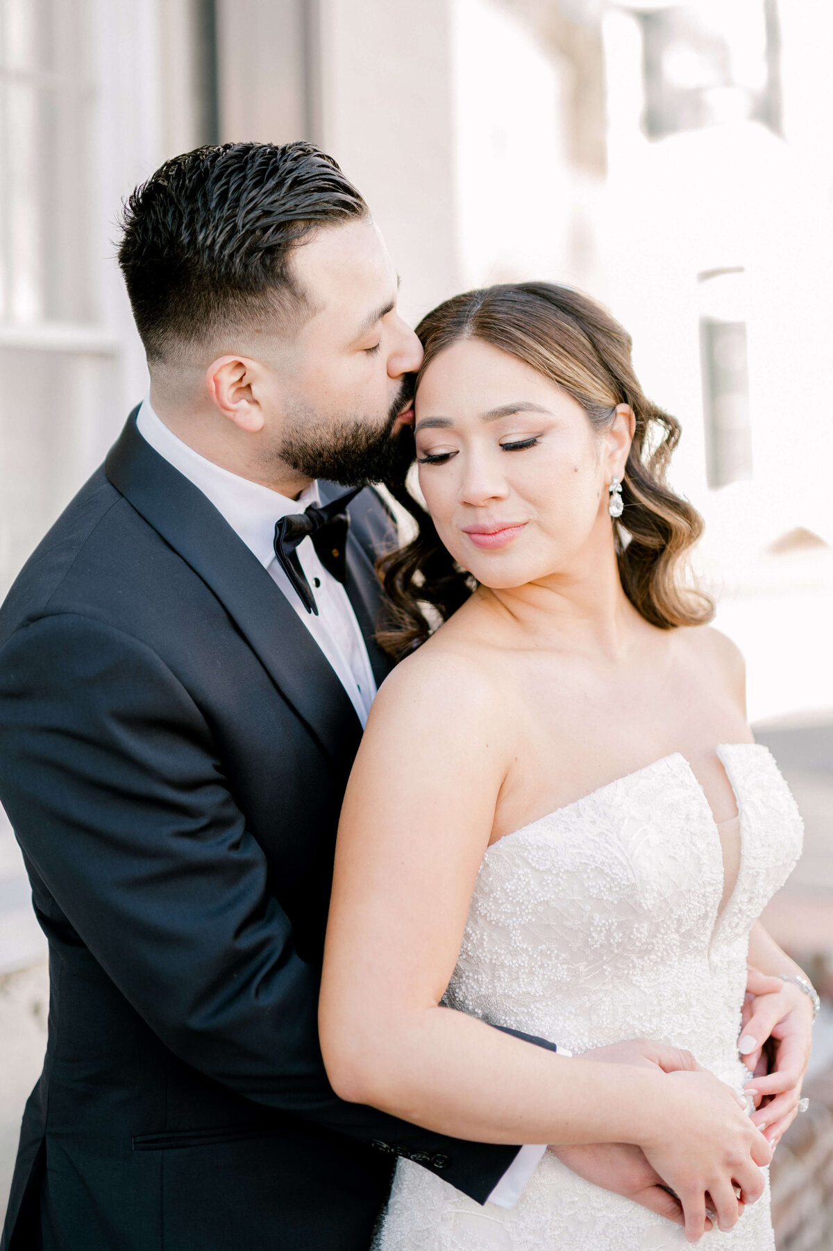 groom kissing bride on forehead for  wedding portraits by Virginia wedding photographer, Rachael Mattio