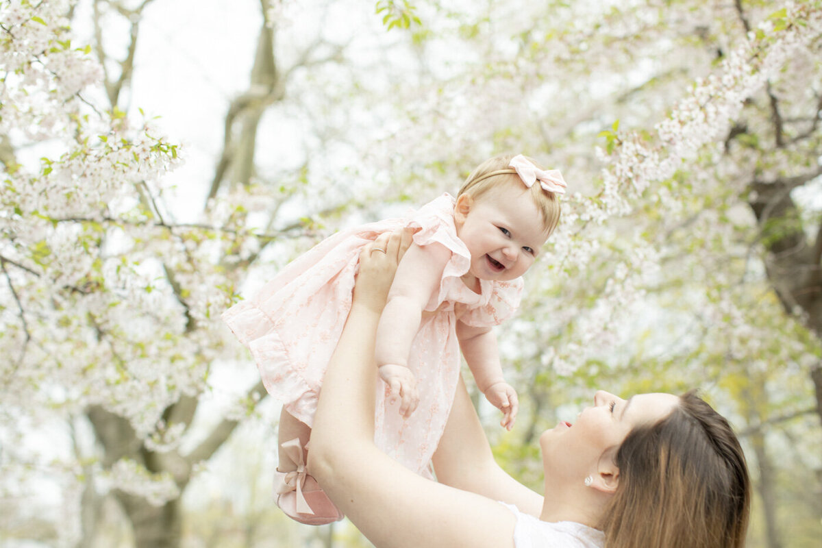 baby girl with mom during family photoshoot at the park